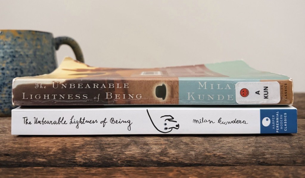 Two different cover editions of the novel The Unbearable Lightness of Being by Milan Kundera, stacked together with books spines sharply in focus.
